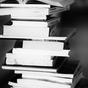 A monochrome image of a tall stack of books symbolizing education and knowledge.